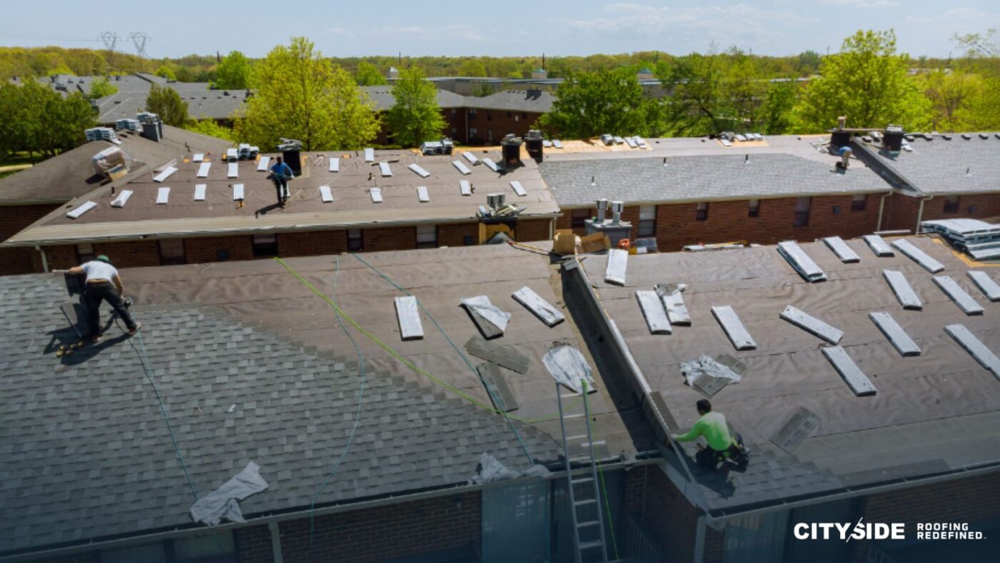 A group of men collaborating on a roof