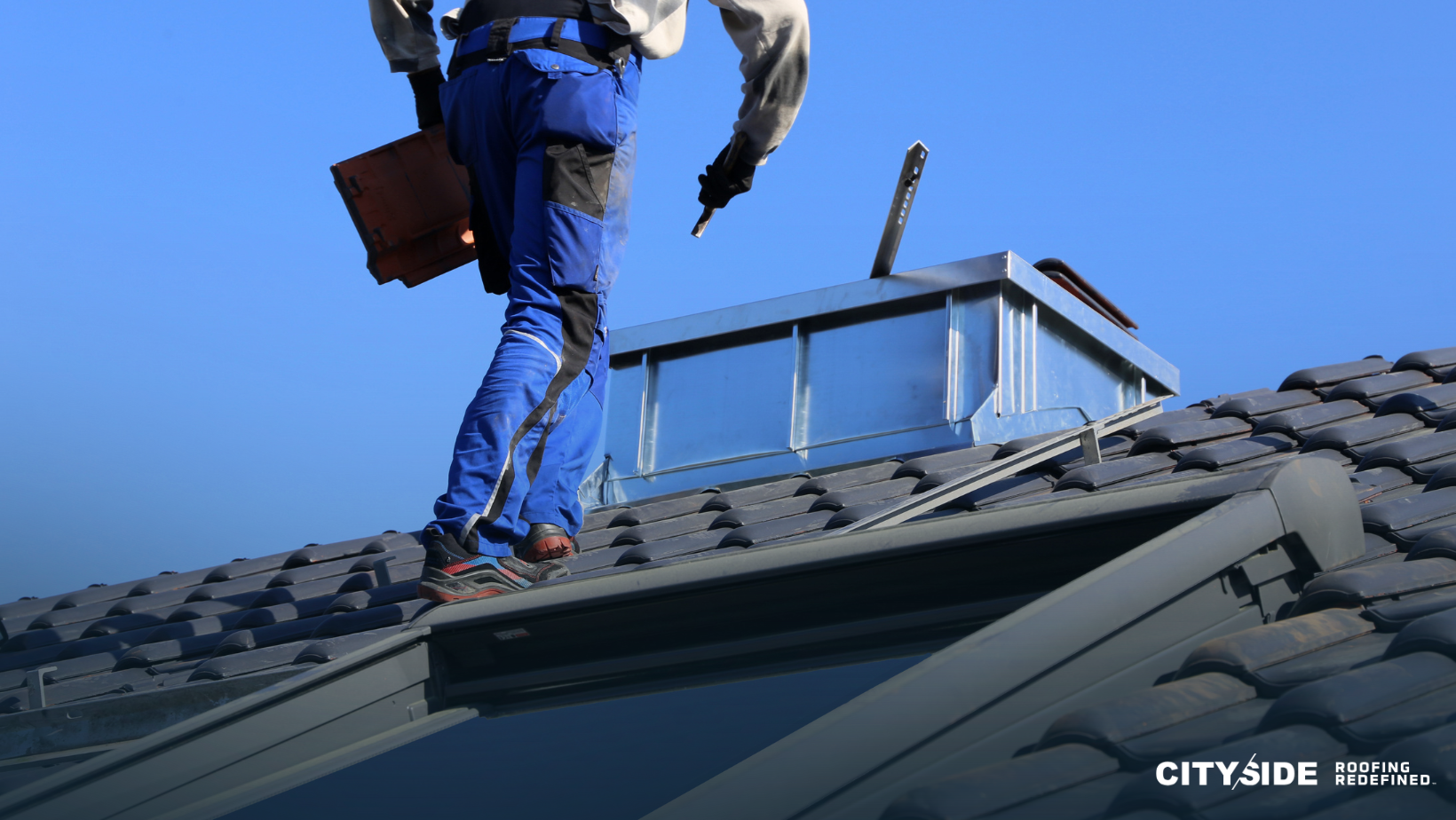 A man stands confidently on the roof of a house, overlooking the surroundings with a thoughtful expression.