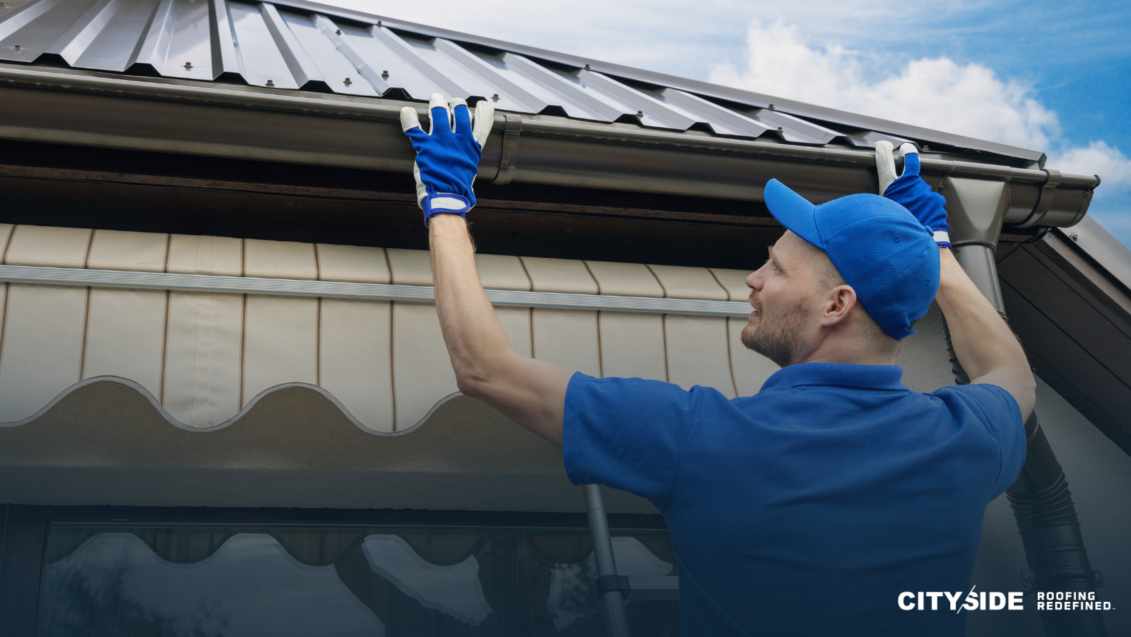 A man wearing a blue shirt and blue gloves repairs a metal roof, demonstrating skilled craftsmanship and attention to detail.