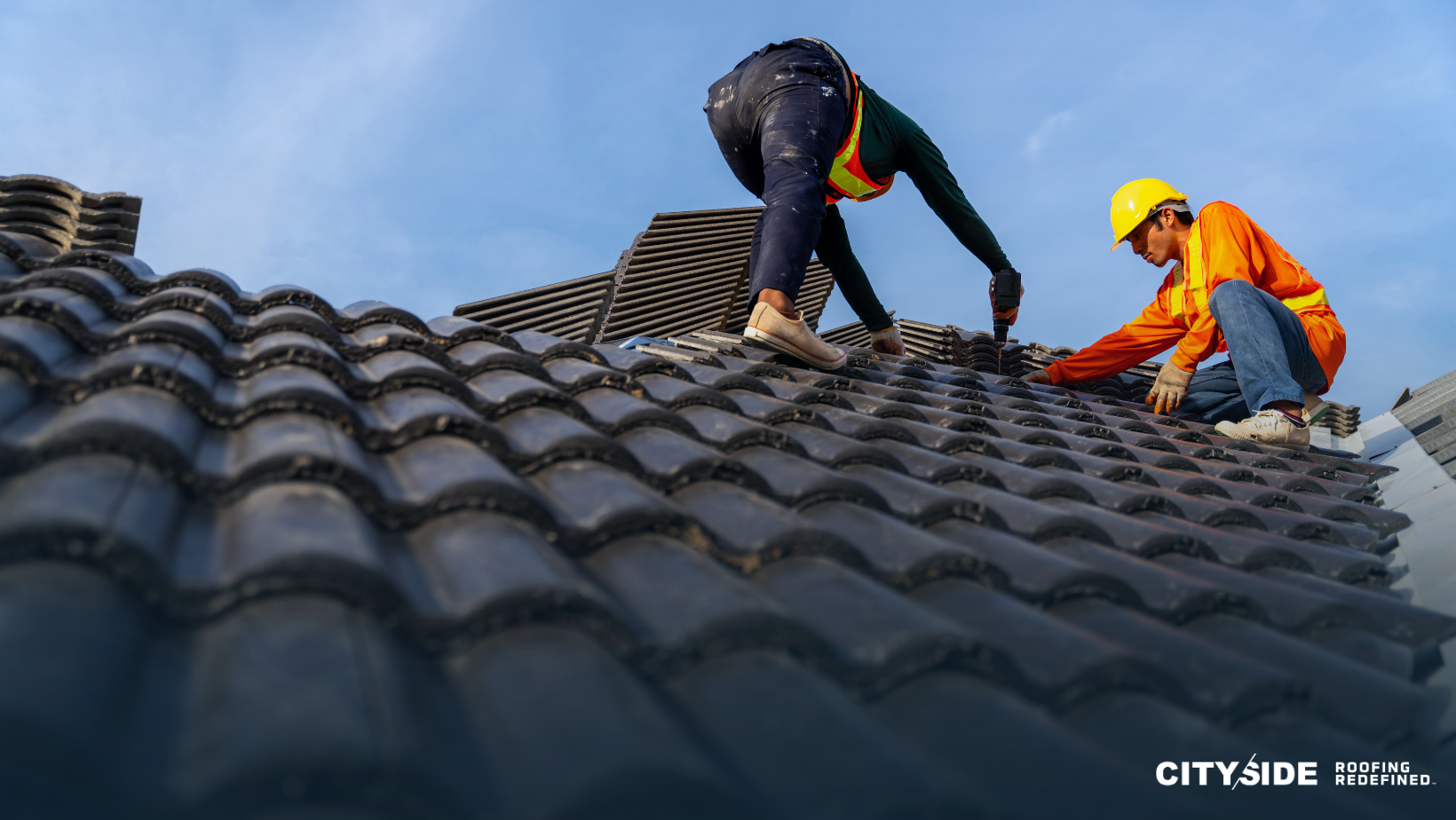  Two men wearing safety helmets are collaborating on a roof, ensuring safety while performing their work.