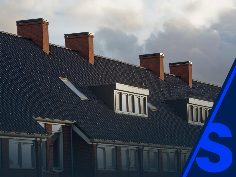 A house featuring a blue roof, prominently displaying a sign with the letter 'S' on it.