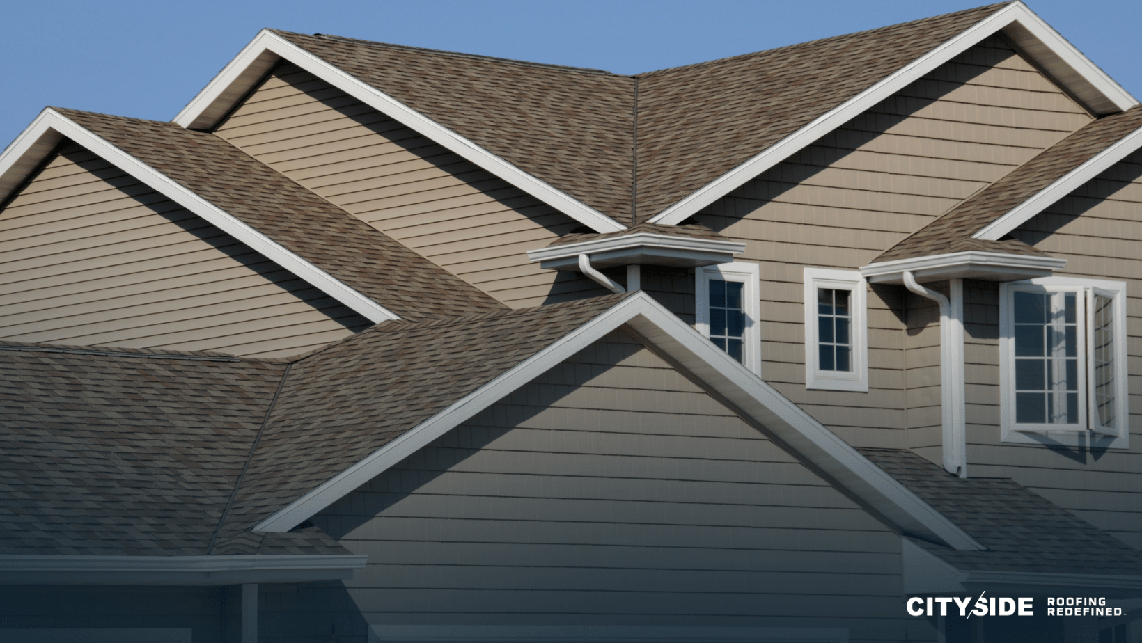 A house exterior featuring a sloped roof and multiple windows, showcasing a classic architectural design.