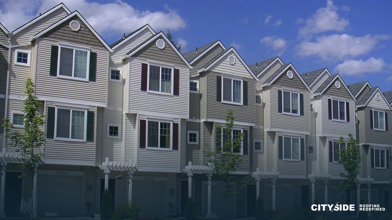 A series of townhouses lined up, each with distinct windows and doors, representing a cozy urban setting.