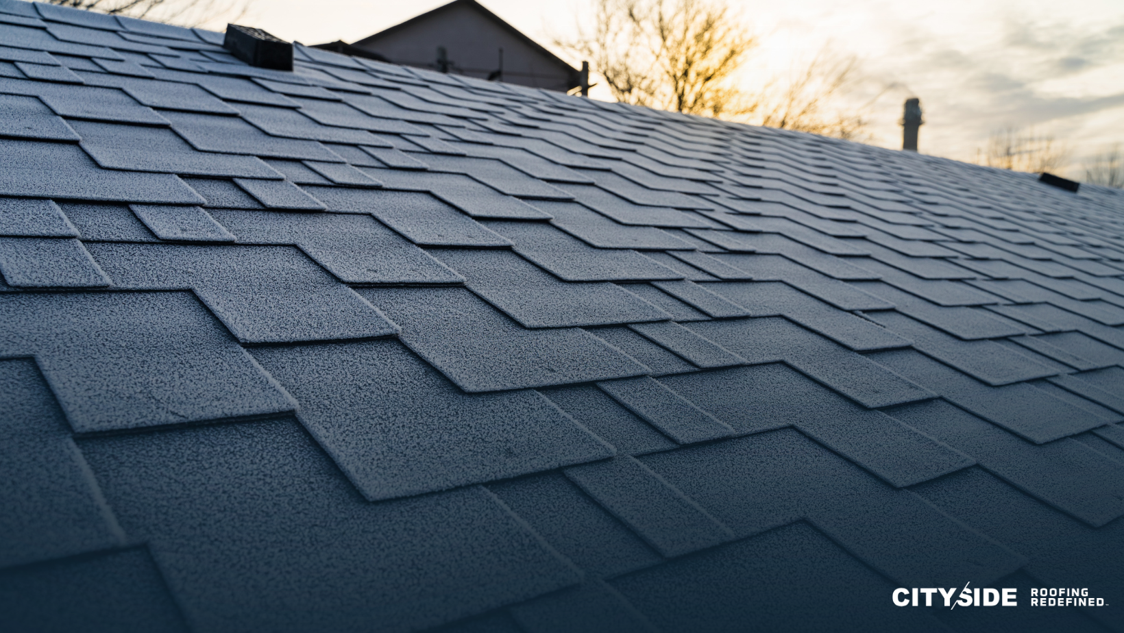 Roof of a house featuring black asphalt shingles with a reflective coating, showcasing durability and modern design.