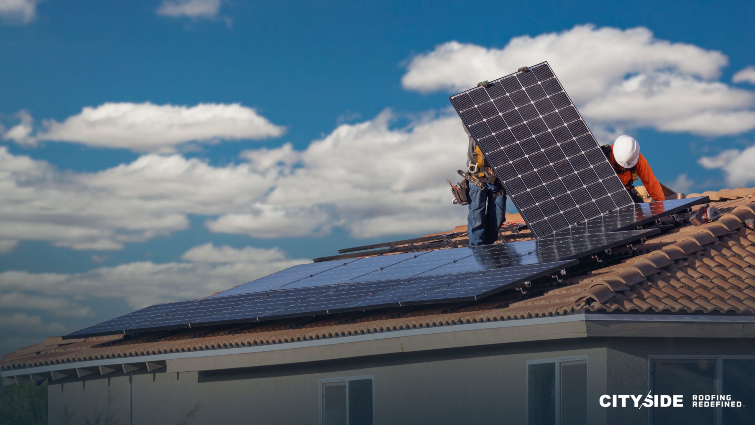 A man installs solar panels on a roof, demonstrating sustainable energy practices and home improvement efforts.