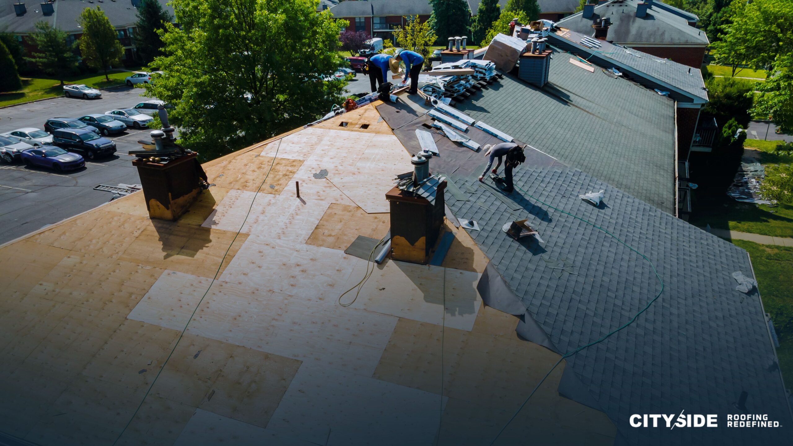 A team of individuals collaborating on a rooftop, engaged in construction or maintenance activities.