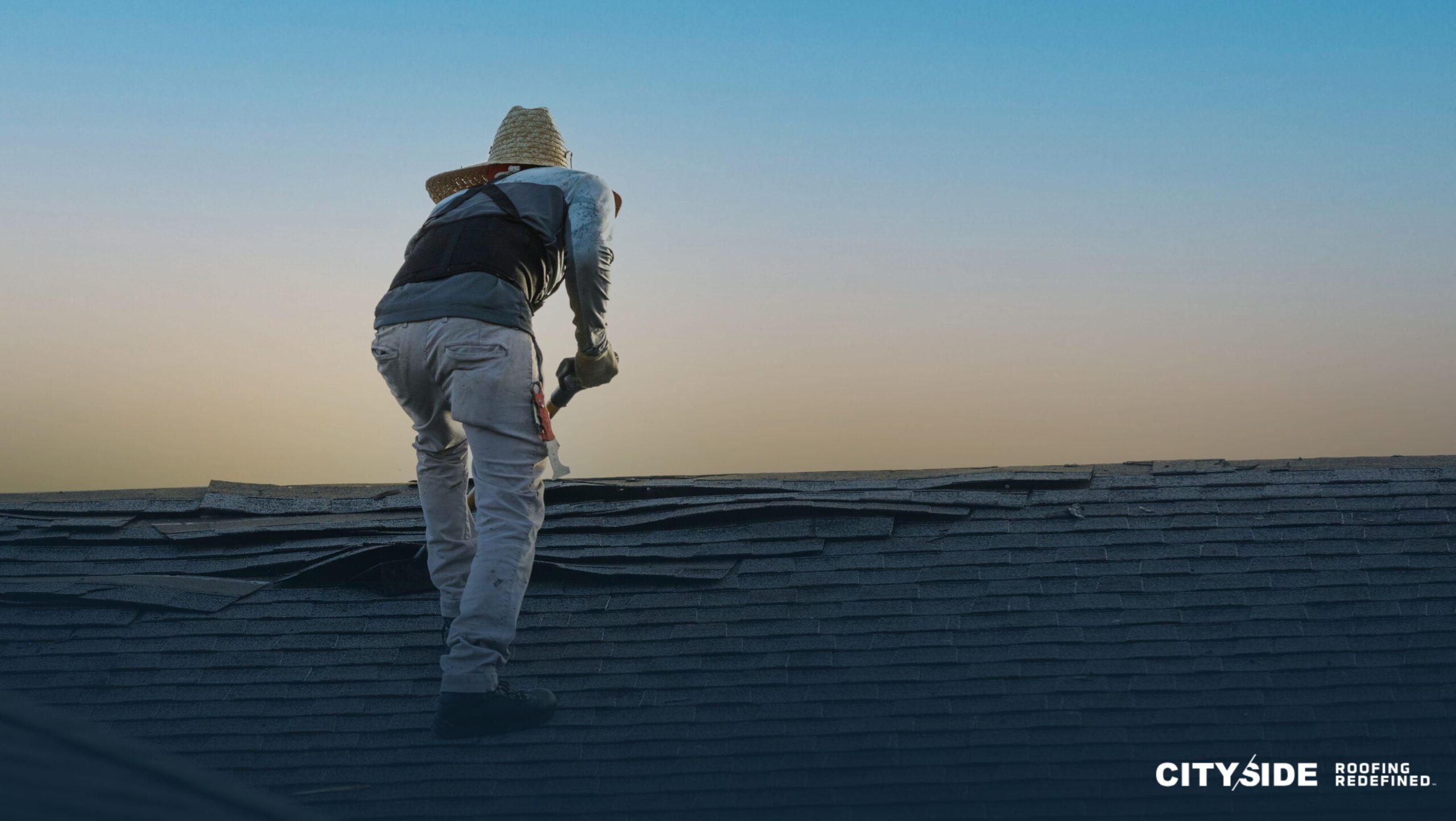 A man stands confidently on the roof of a house, overlooking the surroundings with a thoughtful expression.