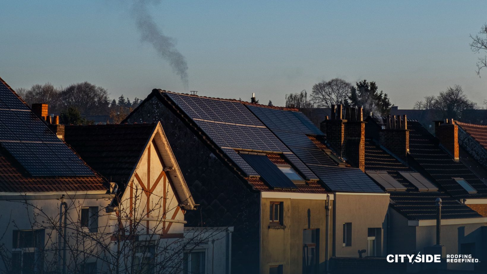 Solar panels installed on rooftops of houses in an urban setting
