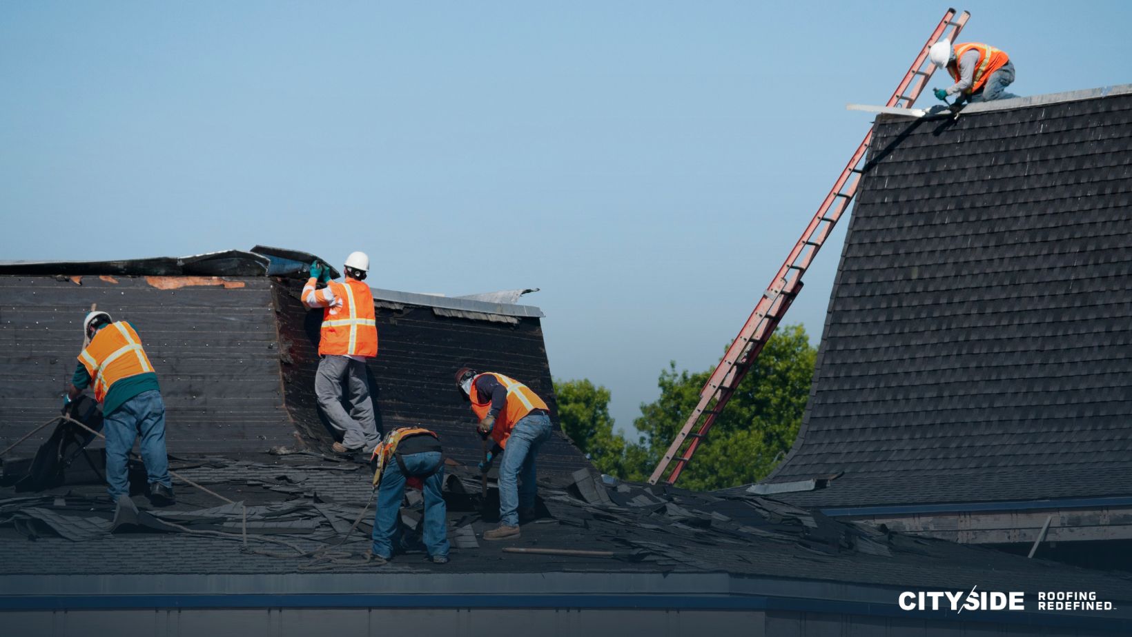 A team of construction workers collaborating on a roof installation