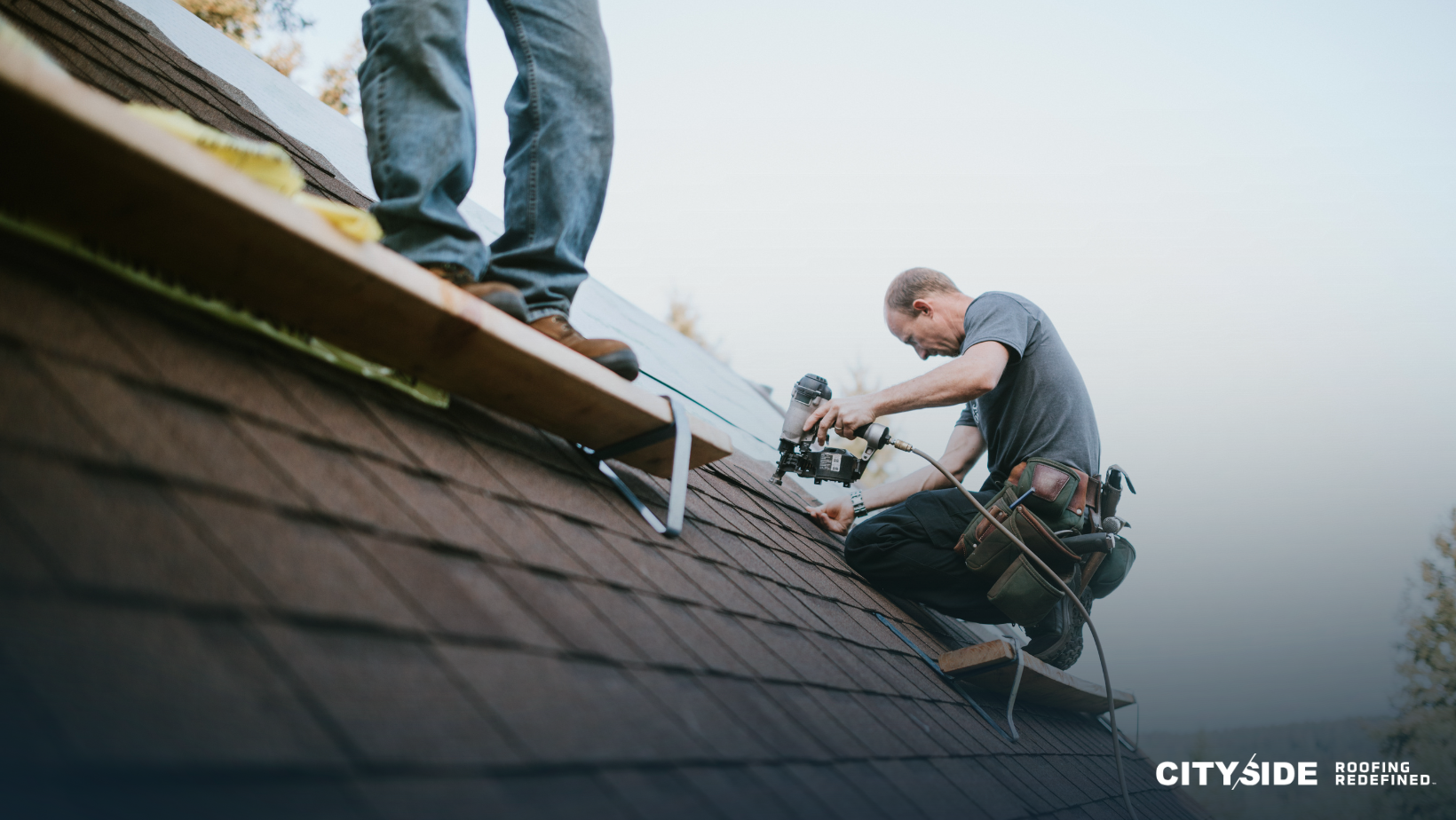Two men working on a roof