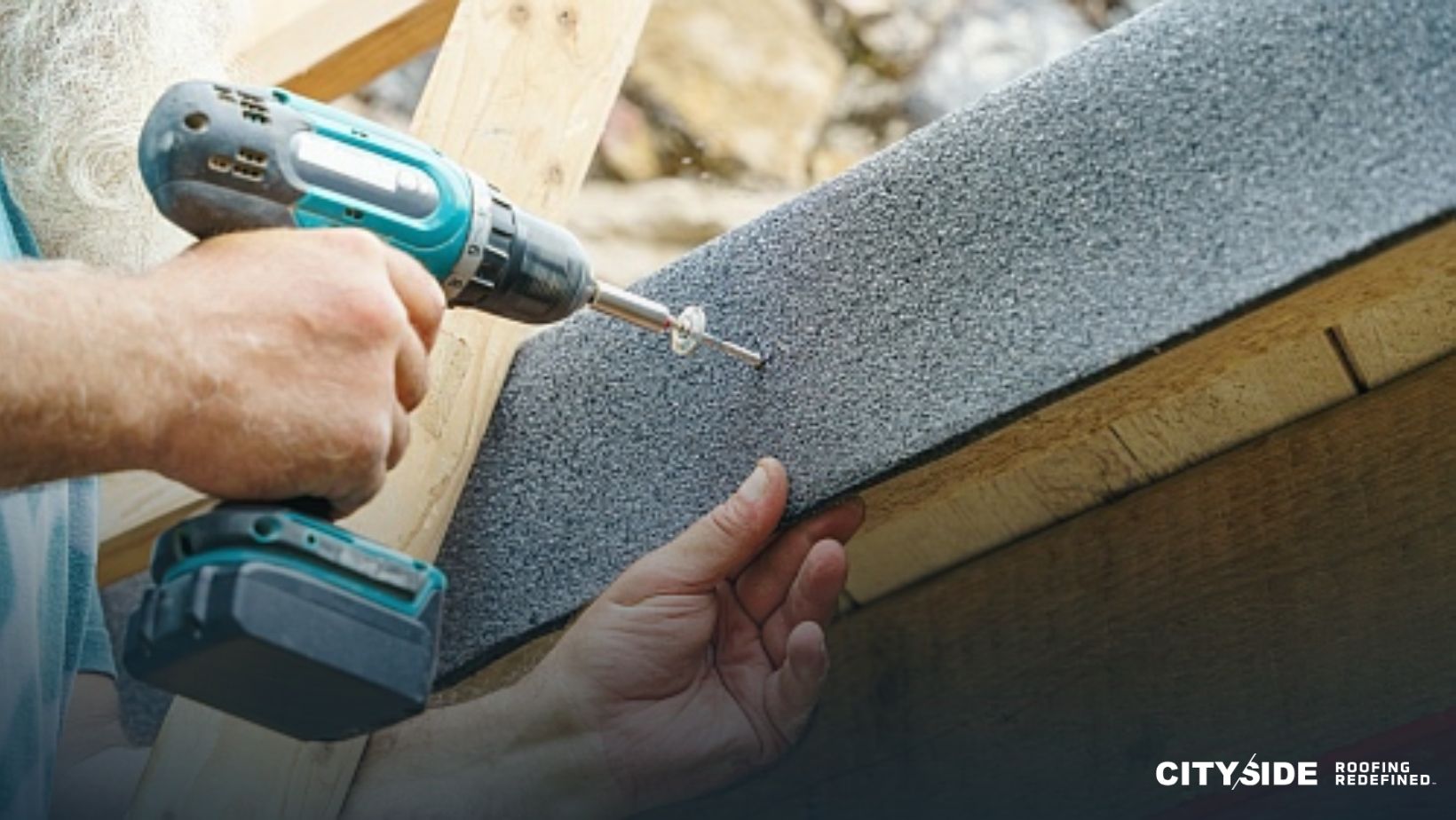 A man drills to install roofing material
