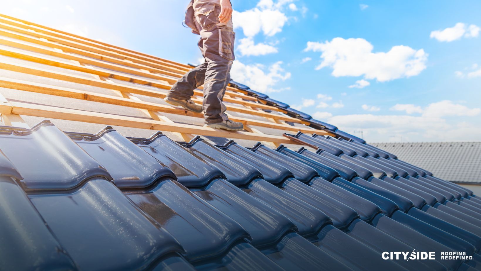 A man stands on the roof of a house