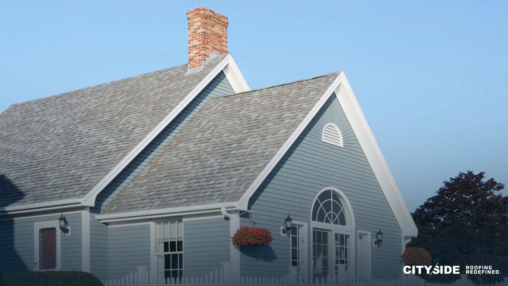A blue house featuring a white chimney against a clear sky.