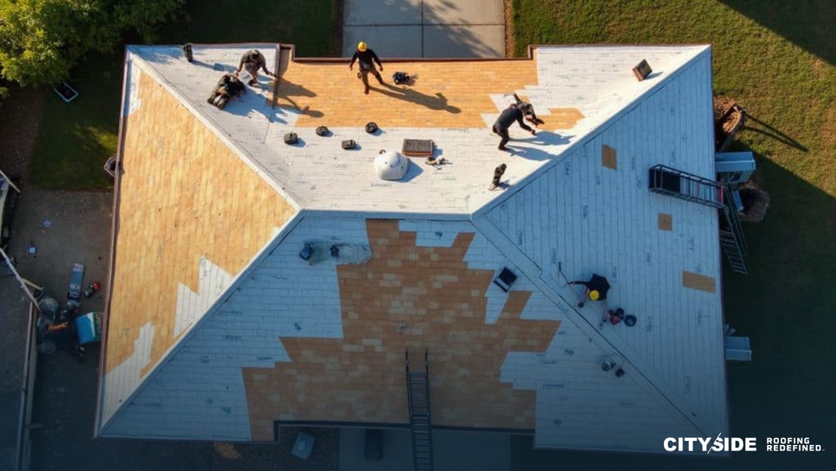 Workers from a roofing company are repairing the roof of a house