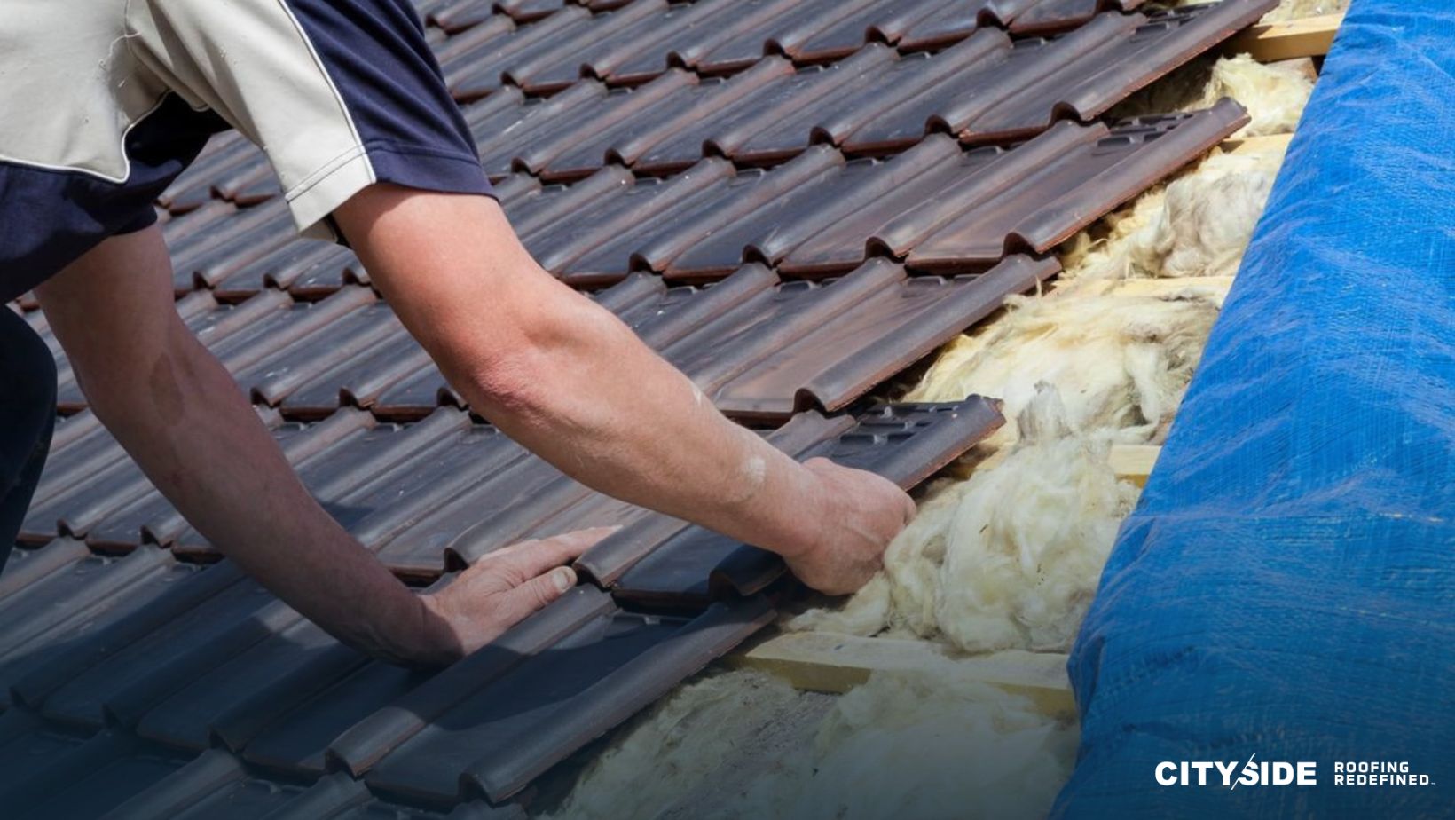 A man installs a tile roof on a house