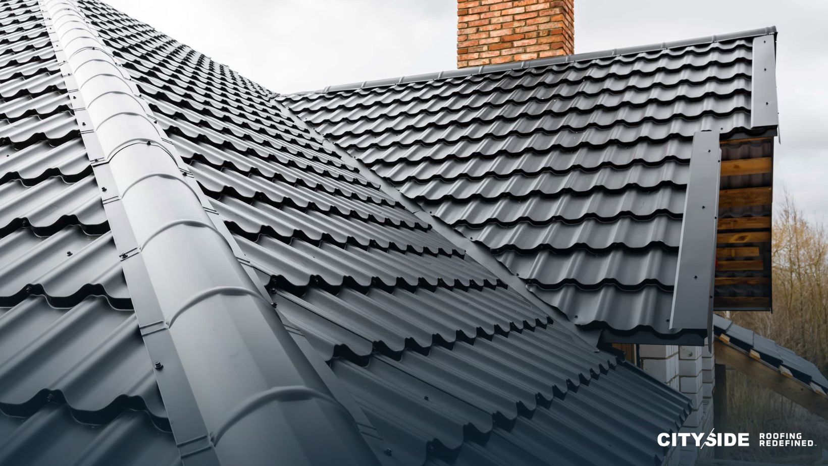 A house roof featuring a prominent chimney against a clear blue sky.