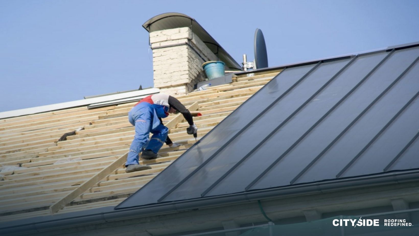A man is installing metal sheets on a roof,