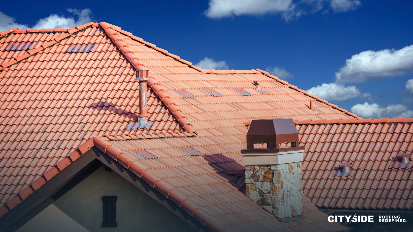A sloped roof with a prominent chimney and a protective chimney cap