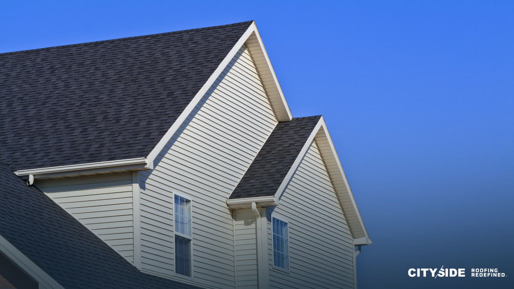 A house featuring a white roof complemented by black shingles