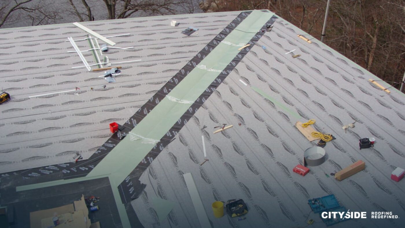 Construction workers are repairing a roof