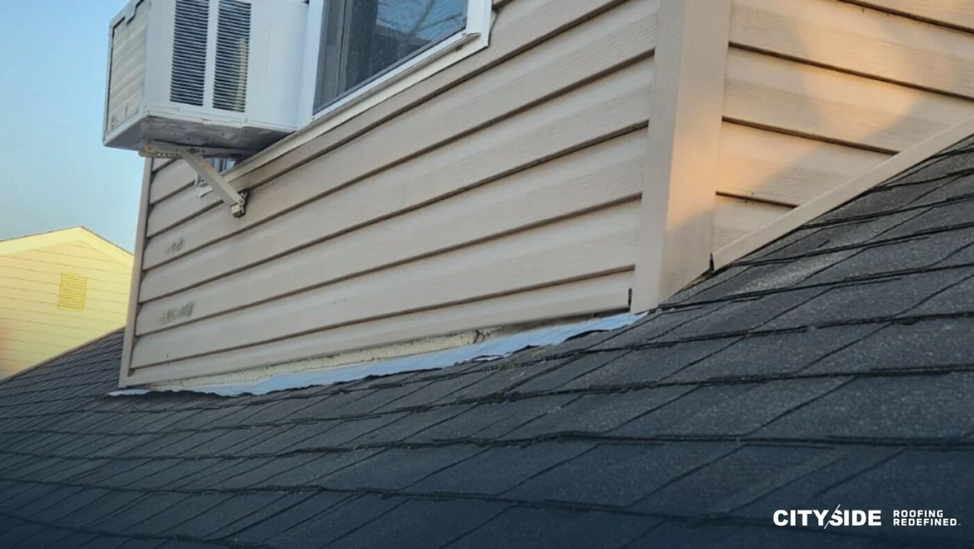 A window air conditioner installed on the side of a house