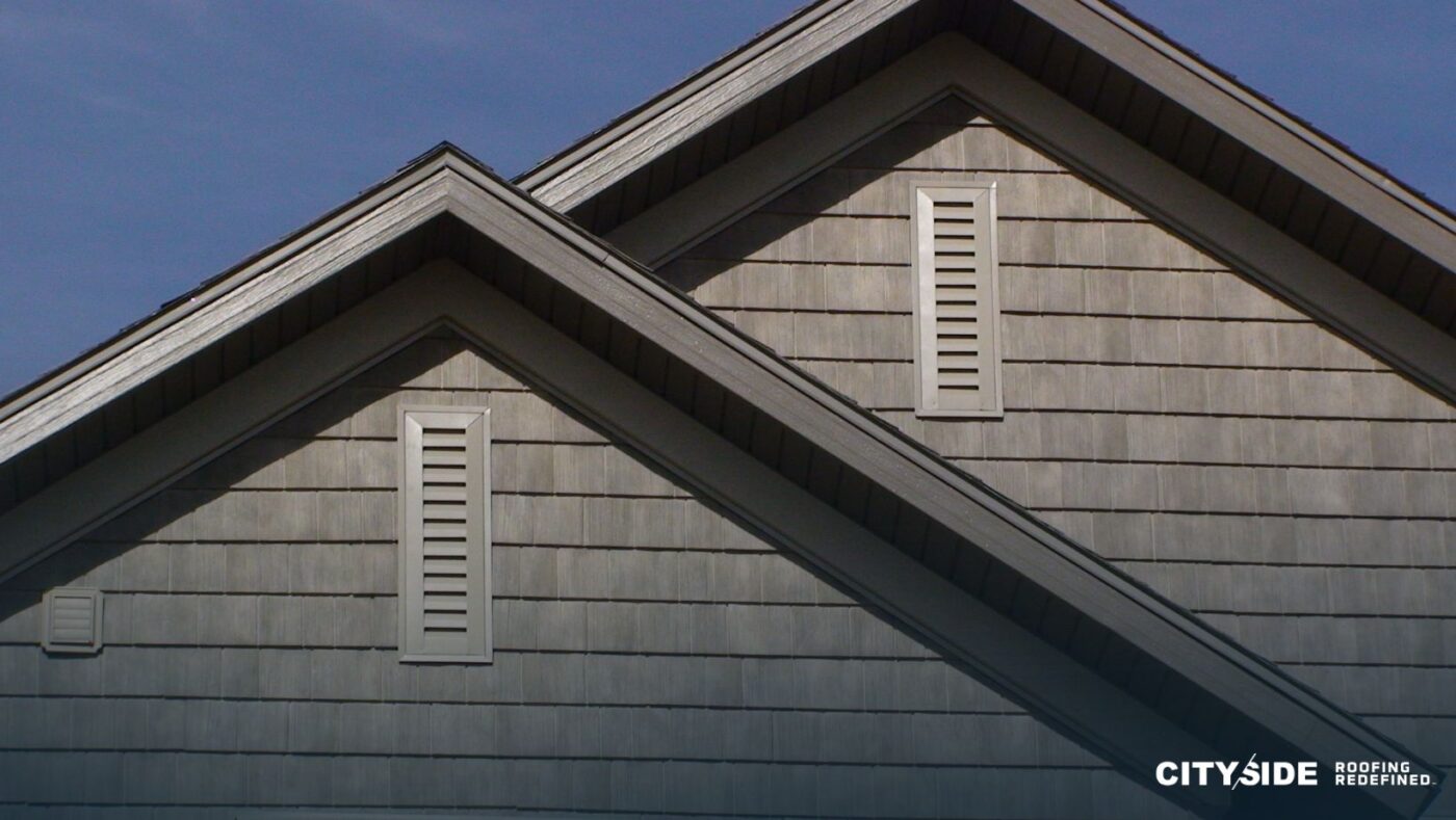 A house roof with a window, showcasing a classic architectural design.