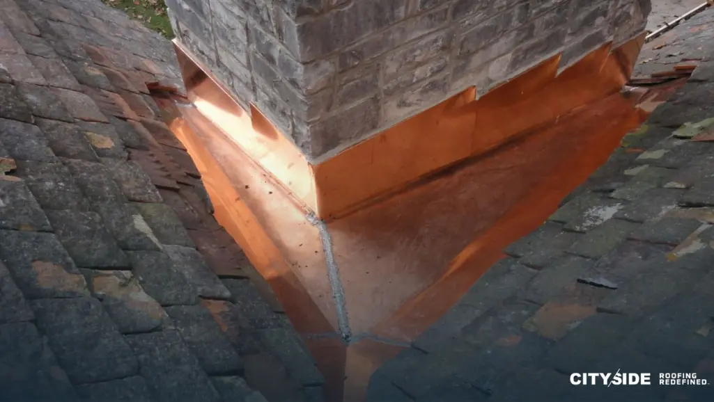 A chimney featuring copper flashing
