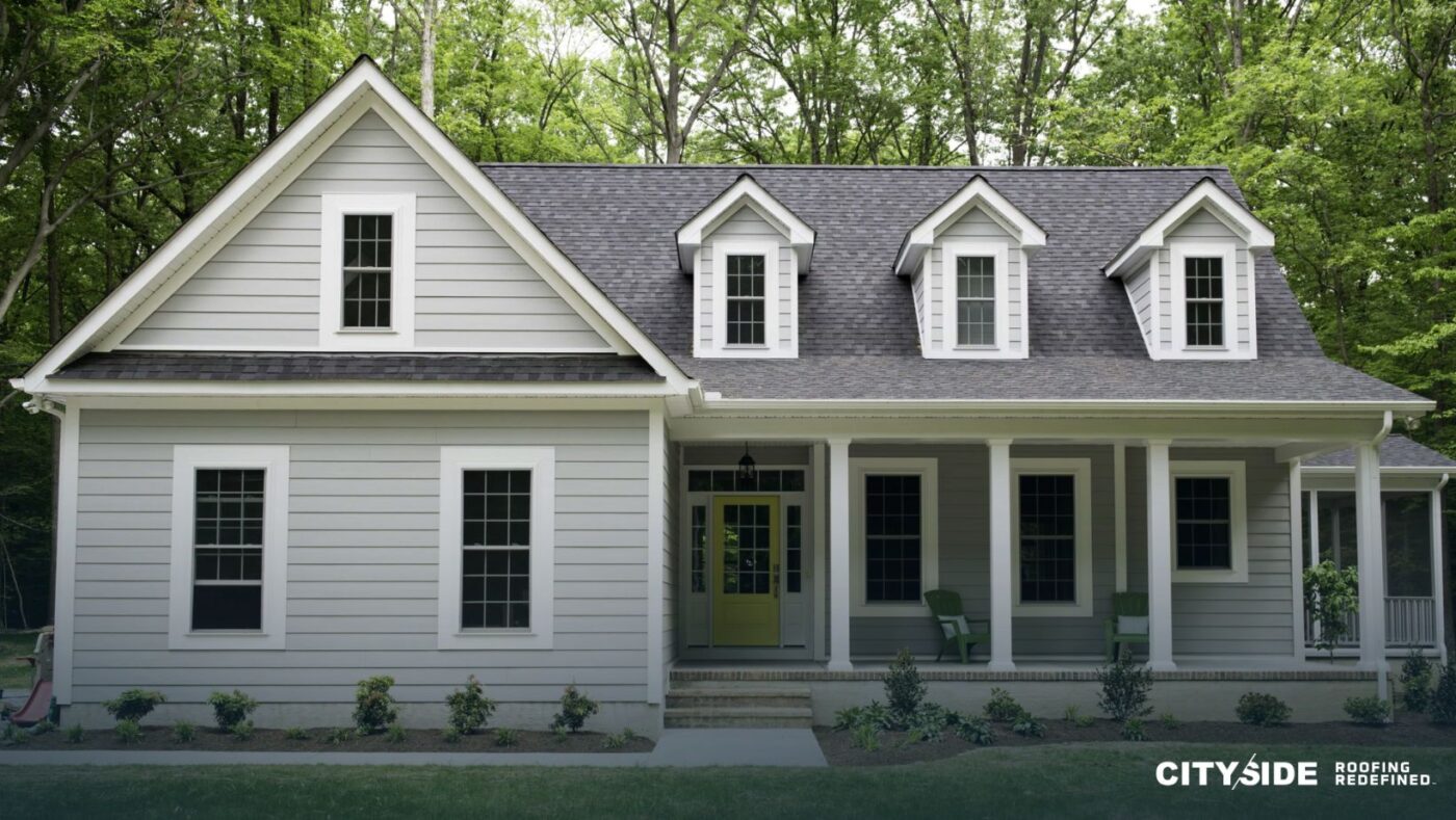A white house featuring black trim and white siding