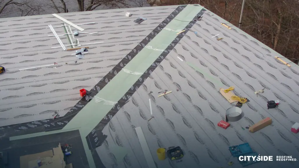 Construction workers are repairing a roof