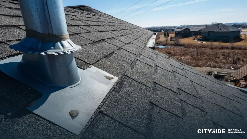 roof with prominent metal vent positioned on its surface. (1)