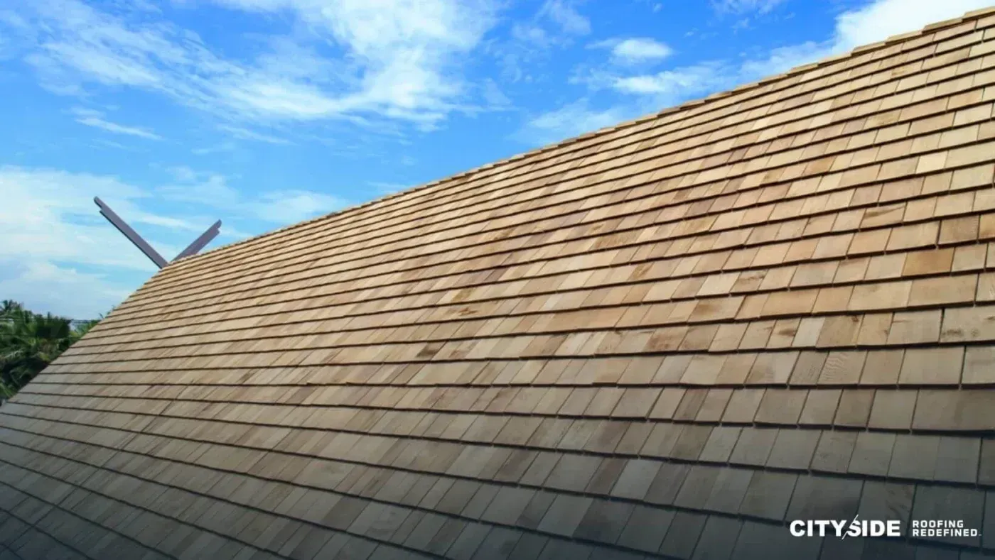 A rustic wooden roof featuring a classic windmill at its peak, surrounded by greenery.