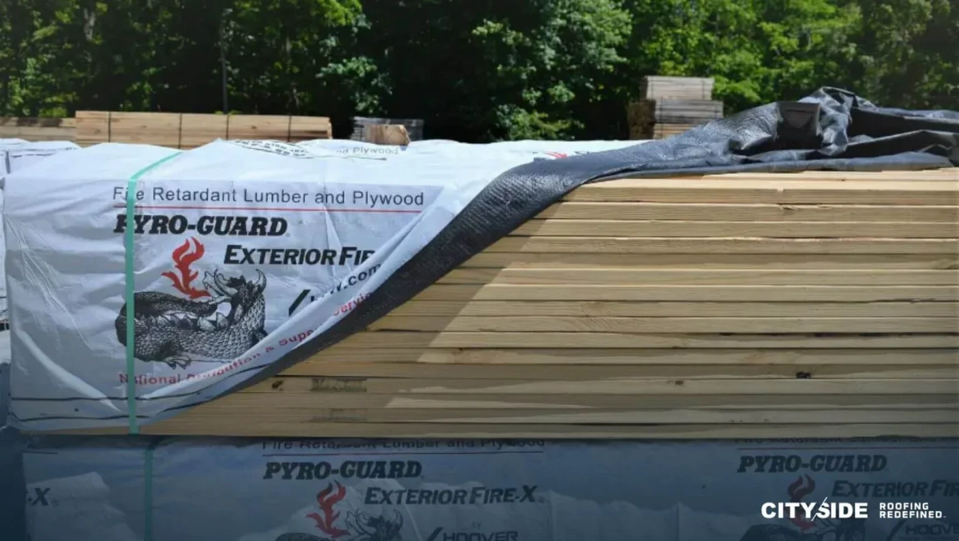 A pile of wooden planks topped with a bag, highlighting the arrangement of construction materials.