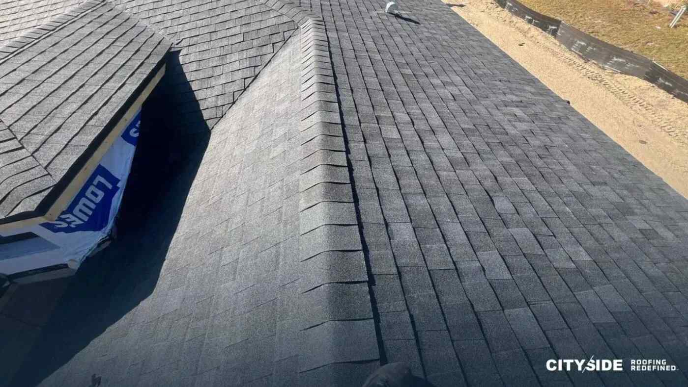 A roof covered with black shingles, showcasing a sleek and modern design.