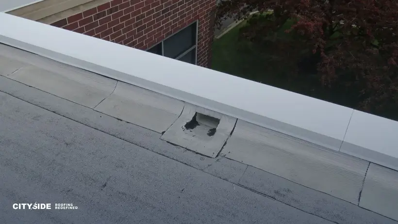 A roof featuring a metal gutter and a metal drain, showcasing a functional drainage system for rainwater management.