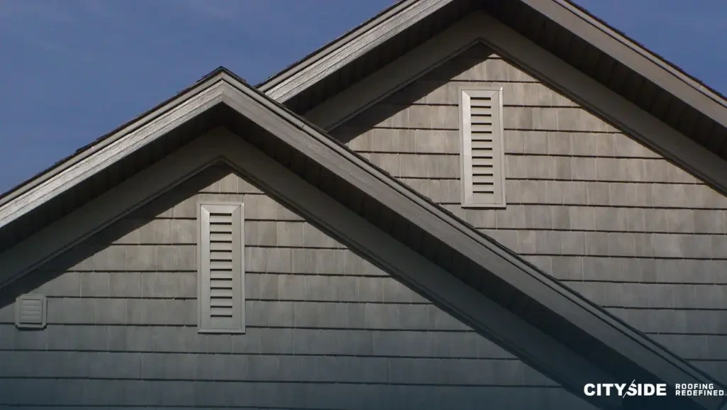 A house roof with a window, showcasing a classic architectural design.