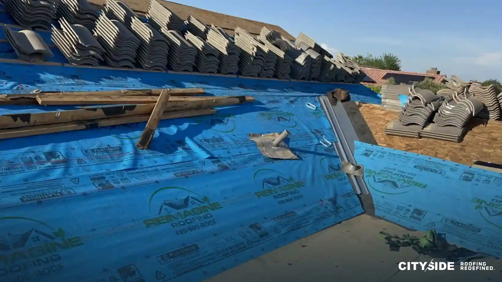 An image of a roofing project showing a blue tarp and a pile of bricks