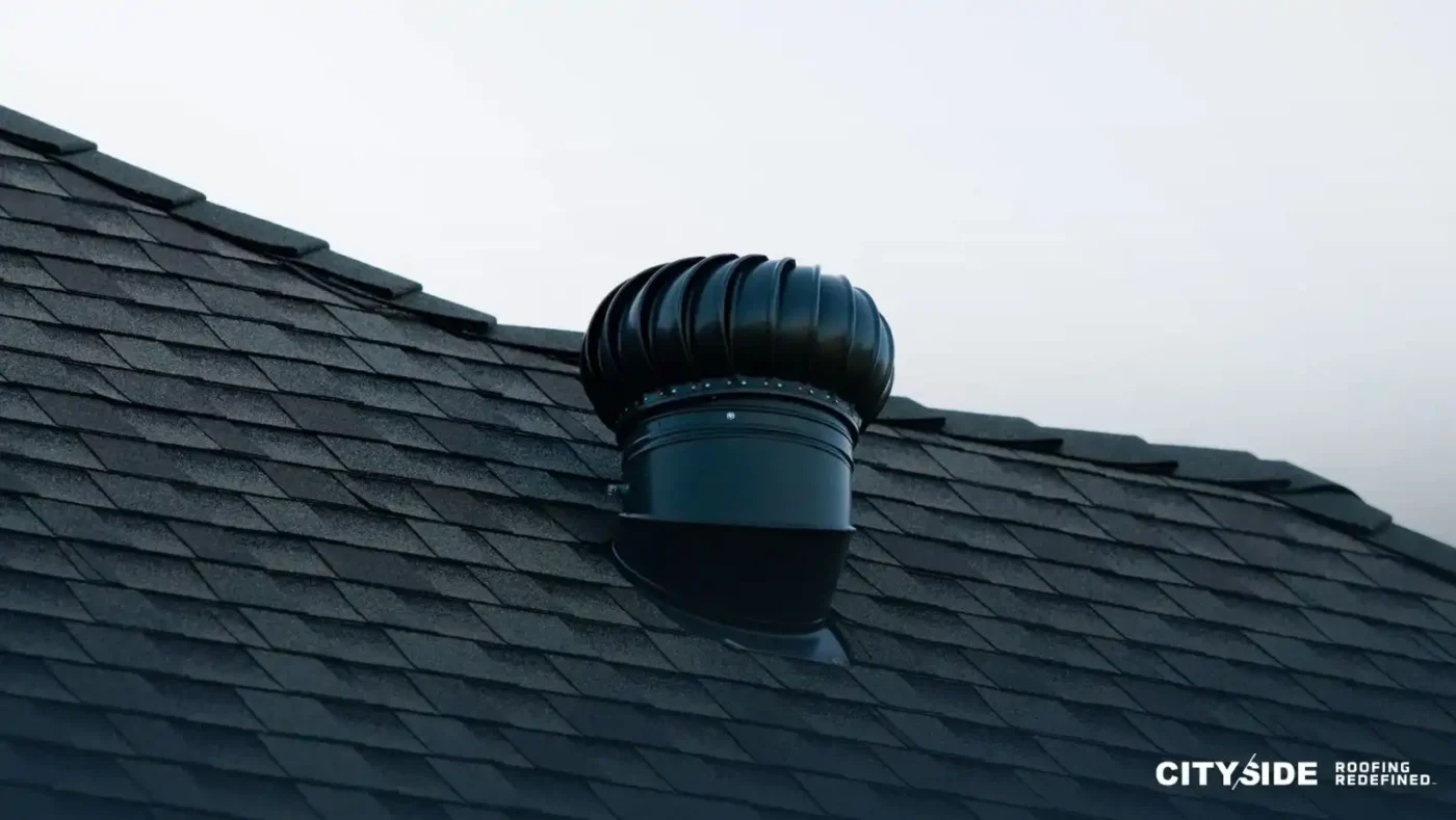 A black roof featuring a matching black chimney positioned at the top.