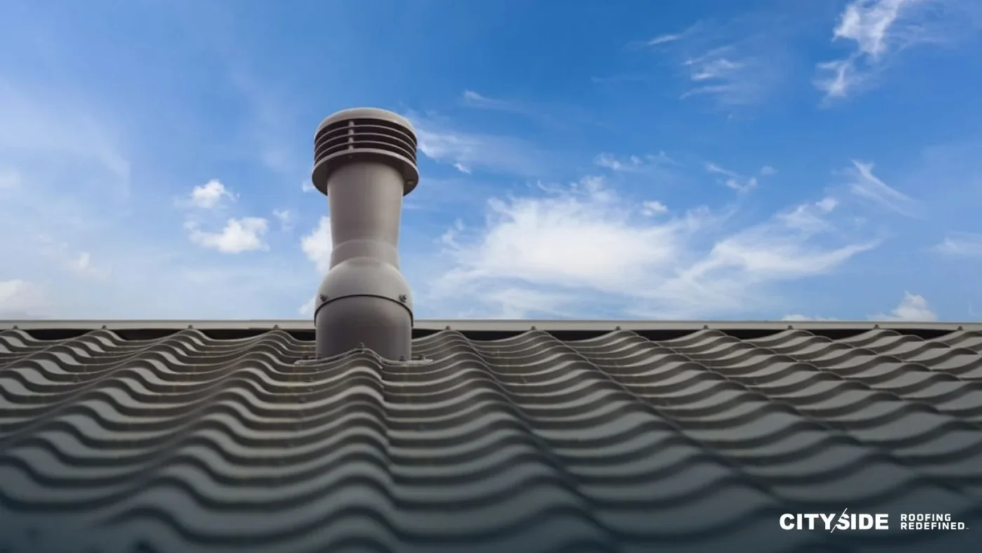 A chimney on a roof against a clear blue sky