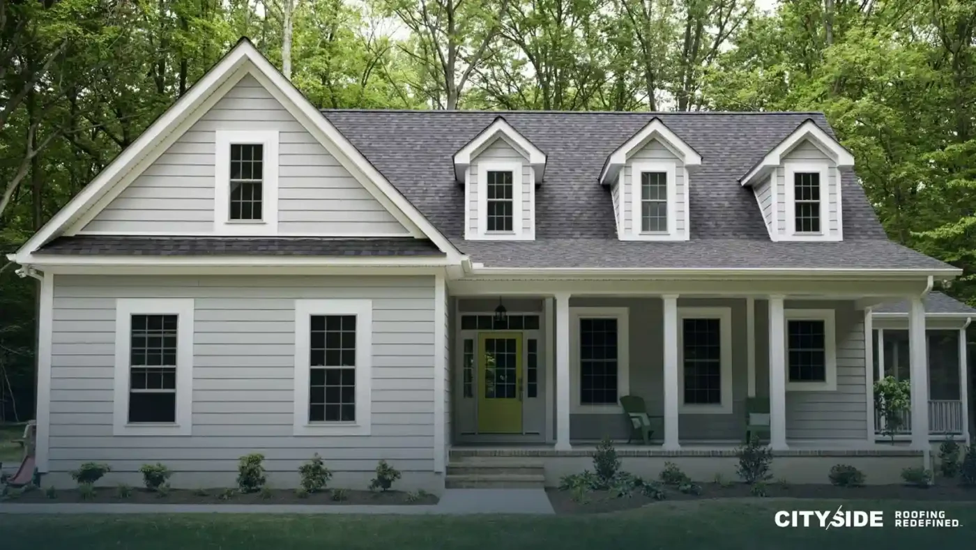 A white house featuring black trim and white siding