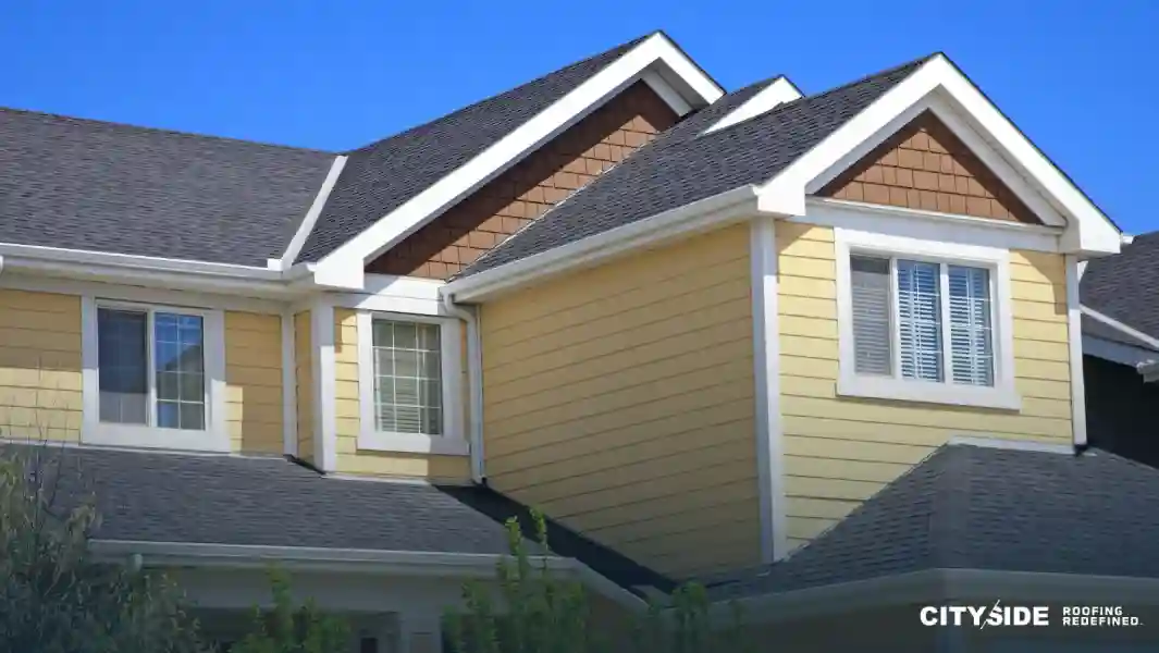 A house featuring a yellow roof and brown trim