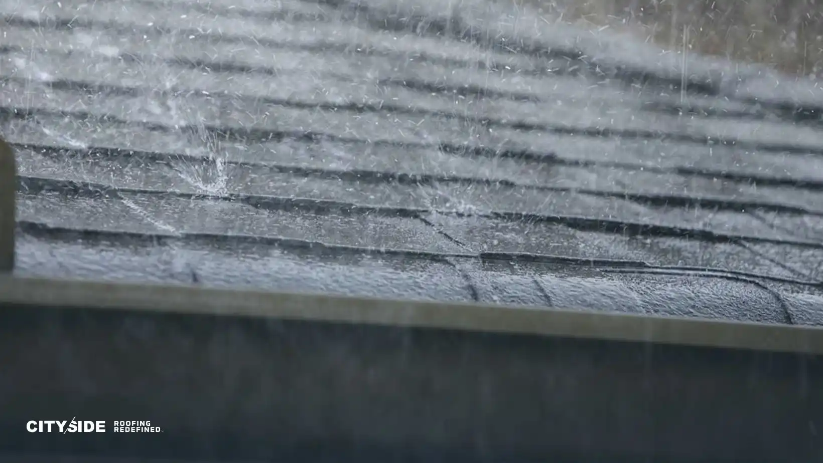Rain splashes on a dark gray shingled roof, illustrating durability and weather resistance. The logo "CitySide Roofing Redefined" is visible in the corner.