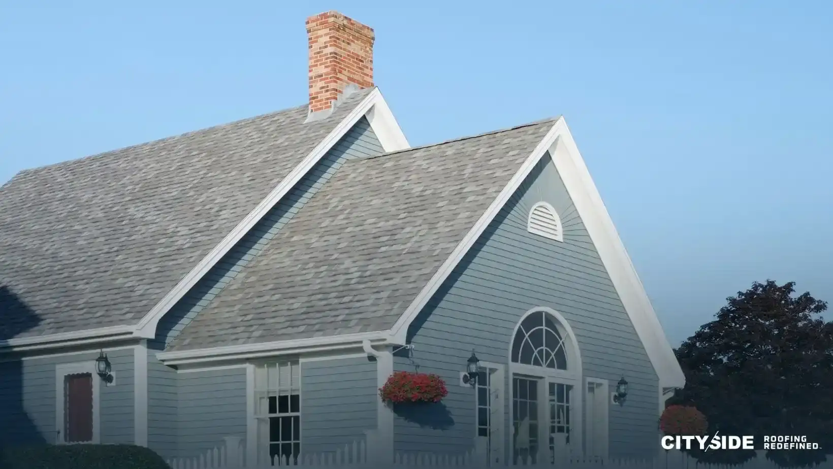 A blue house featuring a white chimney against a clear sky.