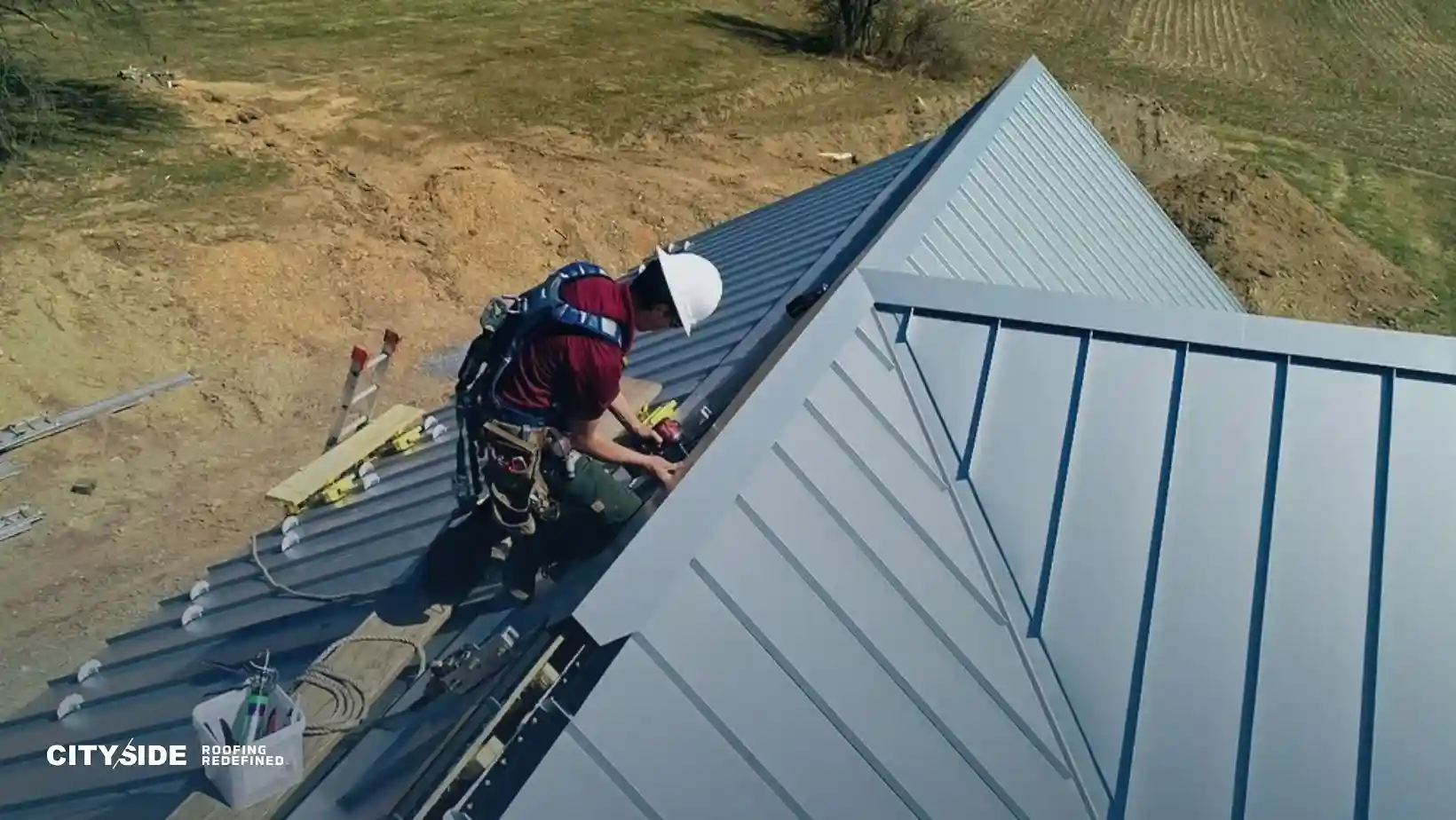 A construction worker in safety gear installs a metal roof on a rural house, conveying focus and precision. A logo reads "Cityside Roofing Redefined."